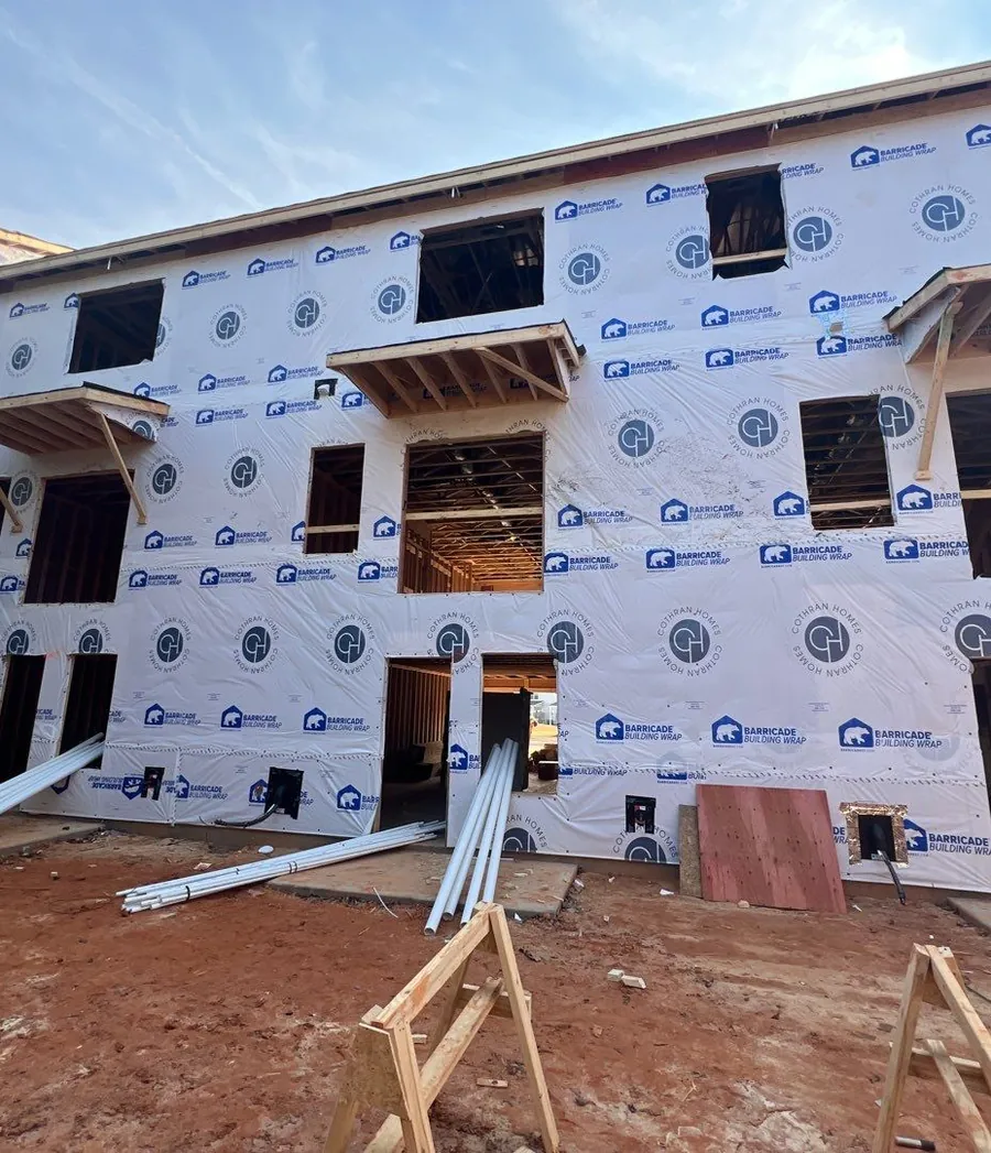 Wrapped three-story townhomes under construction