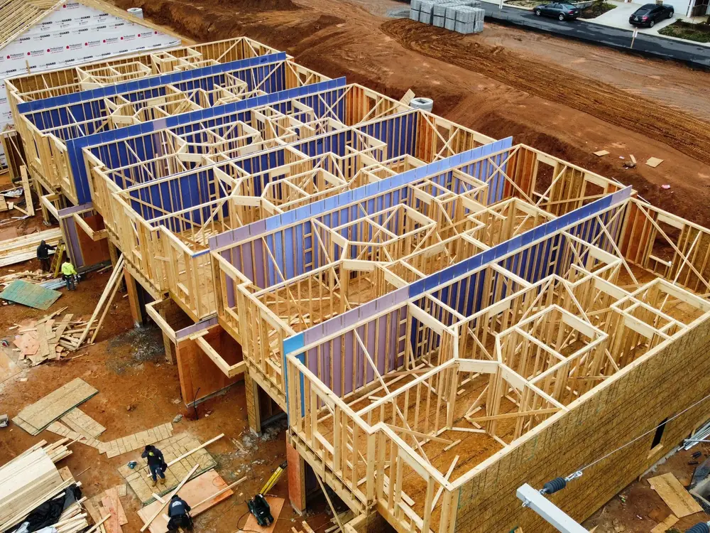 Aerial view of townhome framing with floor trusses set
